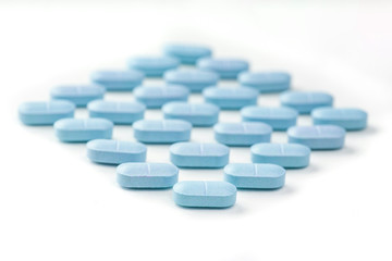 medicine tablets arranged on white background