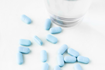 medicine pills with water glass