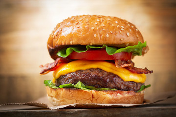 burger with cheese, bacon, salad and vegetables - obrazy, fototapety, plakaty