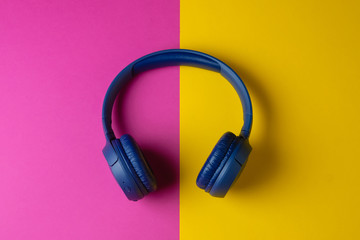 Headphones on a colorful yellow purple background. Webinar or podcast concept.