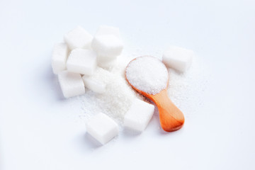 sugar cubes and sugar in spoon. White sugar on white background. Different sugar