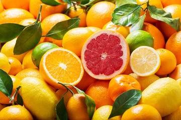 fresh citrus fruits with leaves as background,