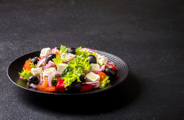 Greek salad of fresh vegetables, olives and feta. Traditional Mediterranean food.