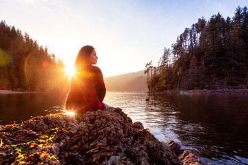 Adventurous Girl Hiking in the Canadian Landscape during a vibrant winter sunset. Hike on Jug...