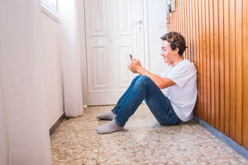 Stay home lockdown quarantine for coronavirus health worldwide emergency covid-19 pandemic epidemic situation concept with young teenager sit down on the floor near the door waiting to go out