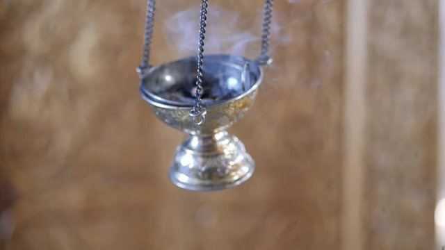 Orthodox tradition. A censer in a Christian Church. Incense smoke comes from the vase.
