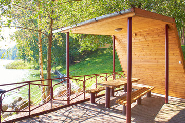 Wooden gazebo on the shore of a large lake