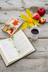 book and cup of coffee on wooden table