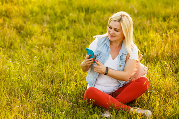 beautiful young blond woman alone in the park