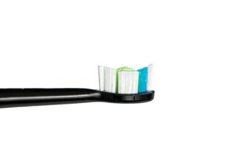 Black toothbrush with blue bristles on a white background isolate