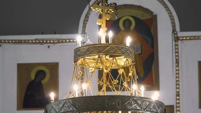 Beautiful gilded chandelier in Church. Stock footage. Panikadilo is main lamp of temple and symbol of Heavenly Church. Openwork patterns Church chandeliers with candles look divine