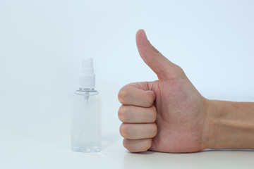 Man hand using wash hand sanitizer pump dispenser for protection coronavirus. health care concept, covid 19. Close Up thumb up hand sanitizer - like or approve sign on white background with copy space