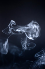 Smoke curves and shapes on dark background