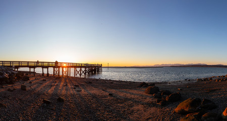 Beautiful Panoramic View of a park by the Pacific Ocean Shore, Blackie Spit, during a vibrant sunny winter sunset. Located in White Rock, Vancouver, British Columbia, Canada. Panorama