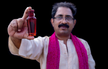 Senior man holding something with hand and showing at camera