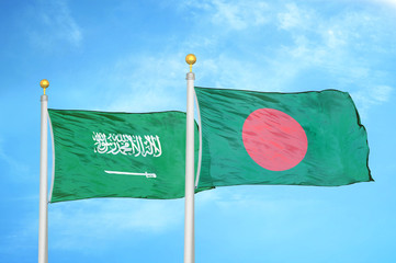 Saudi Arabia and Bangladesh  two flags on flagpoles and blue cloudy sky