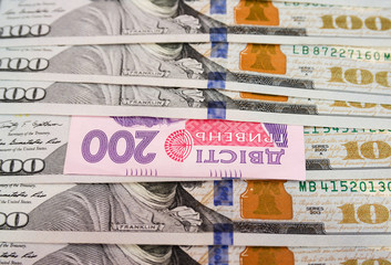 200 hryvnias among dollars. The concept of inflation, financial crisis. Close-up. Money background.
