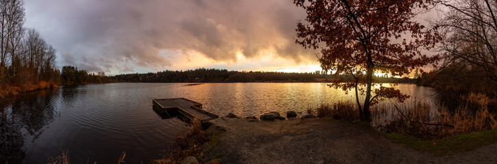 Burnaby, Greater Vancouver, British Columbia, Canada. Beautiful Panoramic View of Deer Lake during a colorful and vibrant winter sunset with Metrotown Buildings in the Background. Panorama