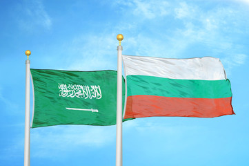 Saudi Arabia and Bulgaria  two flags on flagpoles and blue cloudy sky