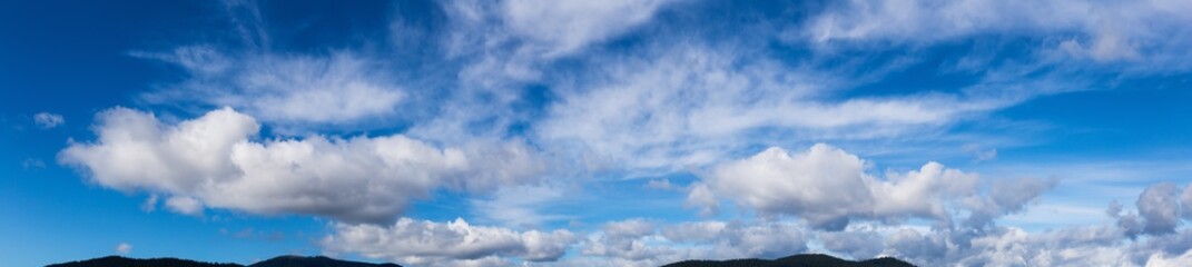 Beautiful Panoramic View of Cloudscape during a colorful and sunny winter day. Taken on the West Coast of British Columbia, Canada.