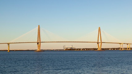 Fototapeta na wymiar Charleston, South Carolina, USA - February 27, 2020: Arthur Ravenel Jr. Bridge, a cable-stayed bridge over the Cooper River in Sunset in South Carolina, USA. 