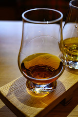 Flight of Scottish whisky, tasting glasses with variety of single malts or blended whiskey spirits on distillery tour in Scotland