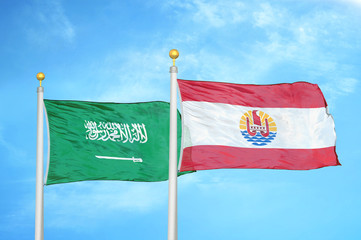 Saudi Arabia and French Polynesia two flags on flagpoles and blue cloudy sky