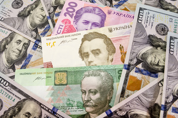100, 200, 20 hryvnias among dollars. The concept of inflation, financial crisis. Close-up. Money...