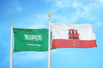 Saudi Arabia and Gibraltar two flags on flagpoles and blue cloudy sky