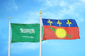 Saudi Arabia and Guadeloupe two flags on flagpoles and blue cloudy sky