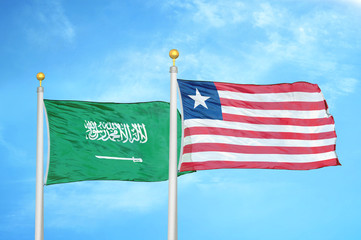 Saudi Arabia and Liberia two flags on flagpoles and blue cloudy sky