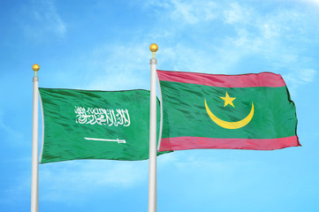 Saudi Arabia and Mauritania two flags on flagpoles and blue cloudy sky