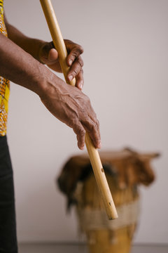 Detail of hands of African American man musician playing the flute with copy space. Online music class learning musical instruments. Rhythm and blues style. Ethnic culture and traditions.