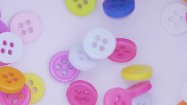 Buttons colorful couture, close up. Fall in slow motion.