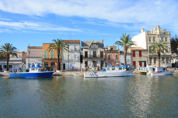 Obraz premium Fishing boats in canal of Grau du roi, a seaside resort on the coast of Occitanie region in France Camargue, 