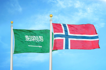 Saudi Arabia and Norway two flags on flagpoles and blue cloudy sky
