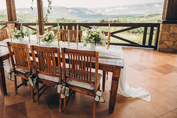 Decorated wedding table for the newlyweds and guests with mountain views. Wedding decor and Floristics.