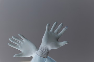 Hands of a man protected from coronavirus. White, latex gloves Protect your palm from infections, viruses, germs. Skin Isolation Symbol protection against the danger of infection. Obstruction, a barri