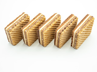 delicious hazelnut cream filled wafers on white background