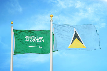 Saudi Arabia and Saint Lucia two flags on flagpoles and blue cloudy sky