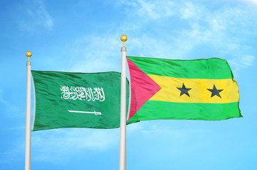 Saudi Arabia and Sao Tome and Principe two flags on flagpoles and blue cloudy sky