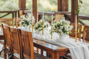 Decorated wedding table for the newlyweds and guests with mountain views. Wedding decor and Floristics.