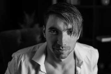 Black and white photo portrait of young man dressed in shirt. sexy man