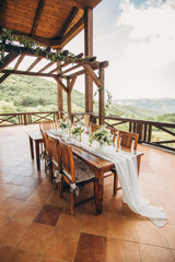 Decorated wedding table for the newlyweds and guests with mountain views. Wedding decor and Floristics.