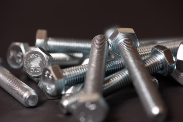 metal bolts isolated on dark background 