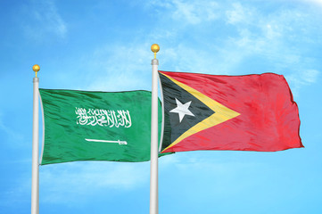 Saudi Arabia and Timor-Leste East Timor two flags on flagpoles and blue cloudy sky