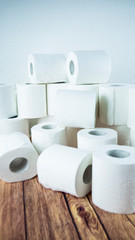 Lots of toilet paper rolls at home of hoarder amidst panic buying for corona virus outbreak shortage in Europe. Last stock of essential products for pandemic. Background photo of bath tissue rolls