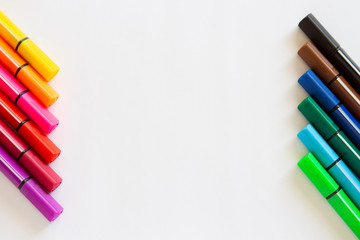 color markers lie on a white background.copyspace for text.