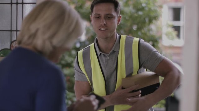 Delivery man at door delivering parcel