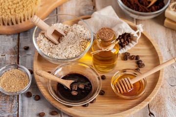 Concept of home beauty care and natural organic ingredients in cosmetology. Coffee, honey, oil, oat for gentle skin peeling and moisturizing. Health care lifestyle. Wooden background closeup